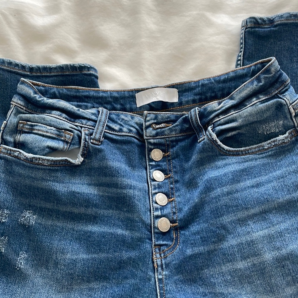 Boyfriend button fly distressed jeans.